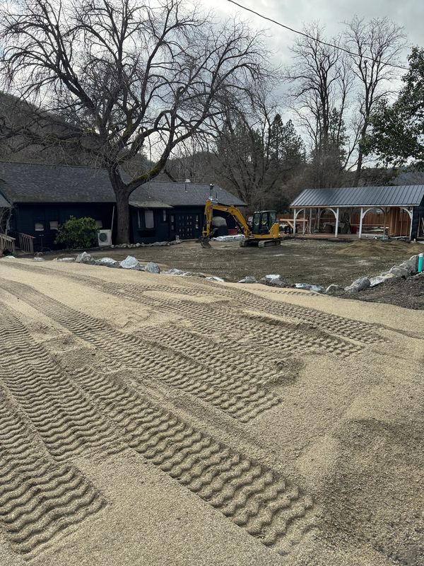 Freshly compacted decomposed-granite base with roller tracks at a Jacksonville, Oregon taproom