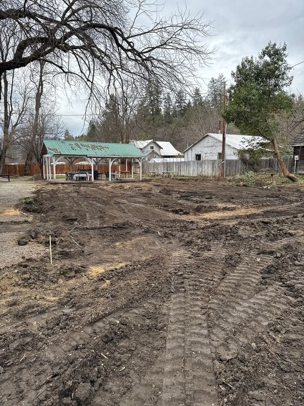 Rough-graded commercial lot ready for base rock during site prep in Jacksonville, Oregon